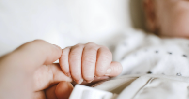 mother calms crying baby by feeding alcohol