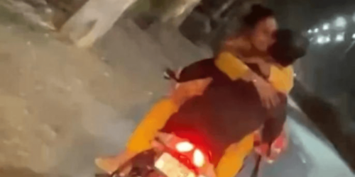 couple kissing on bike riding goes viral