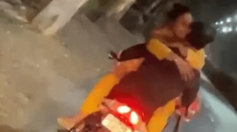 couple kissing on bike riding goes viral